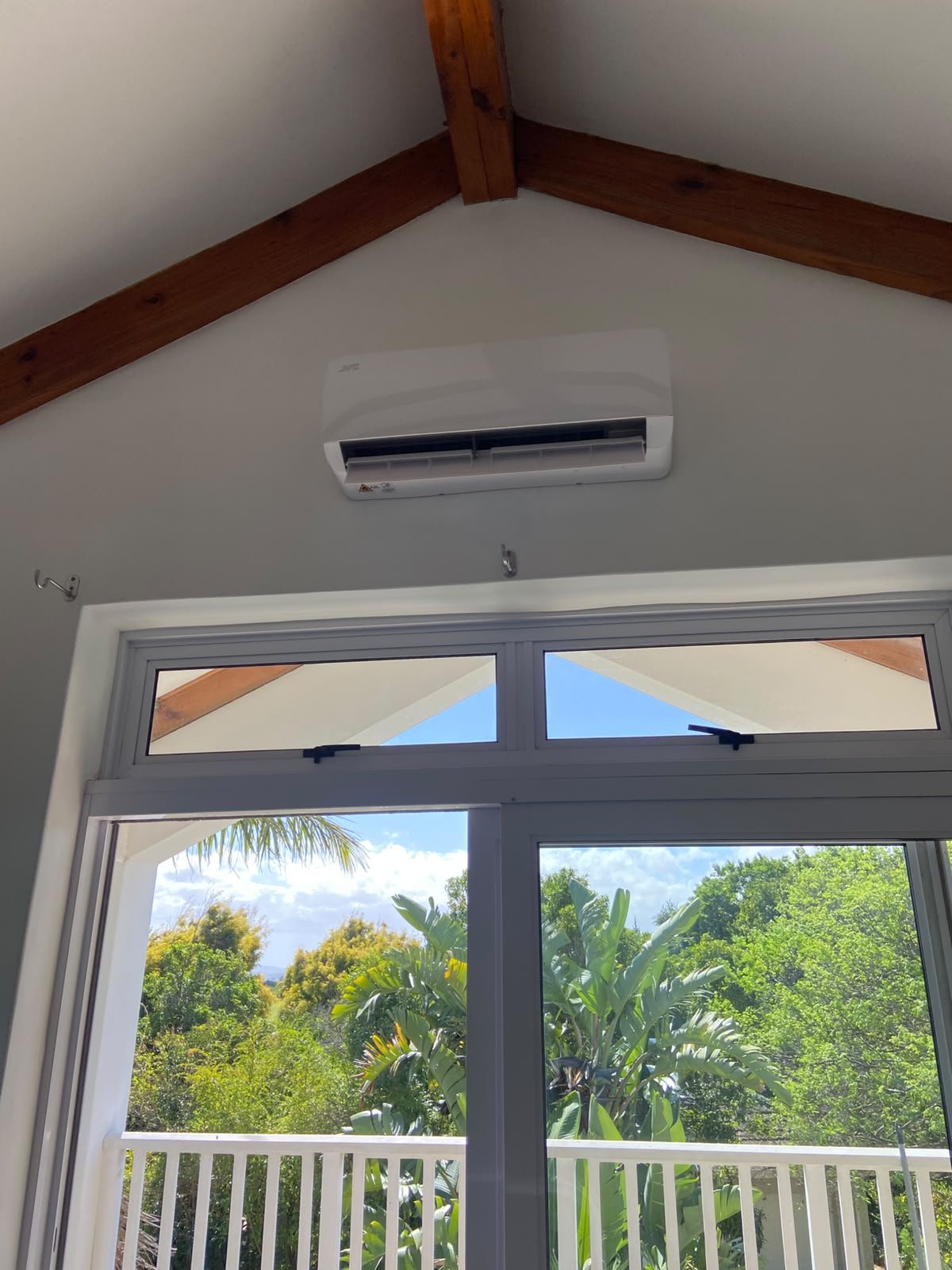 Split aircon indoor unit installed by Mount-IT under timber roof beams
